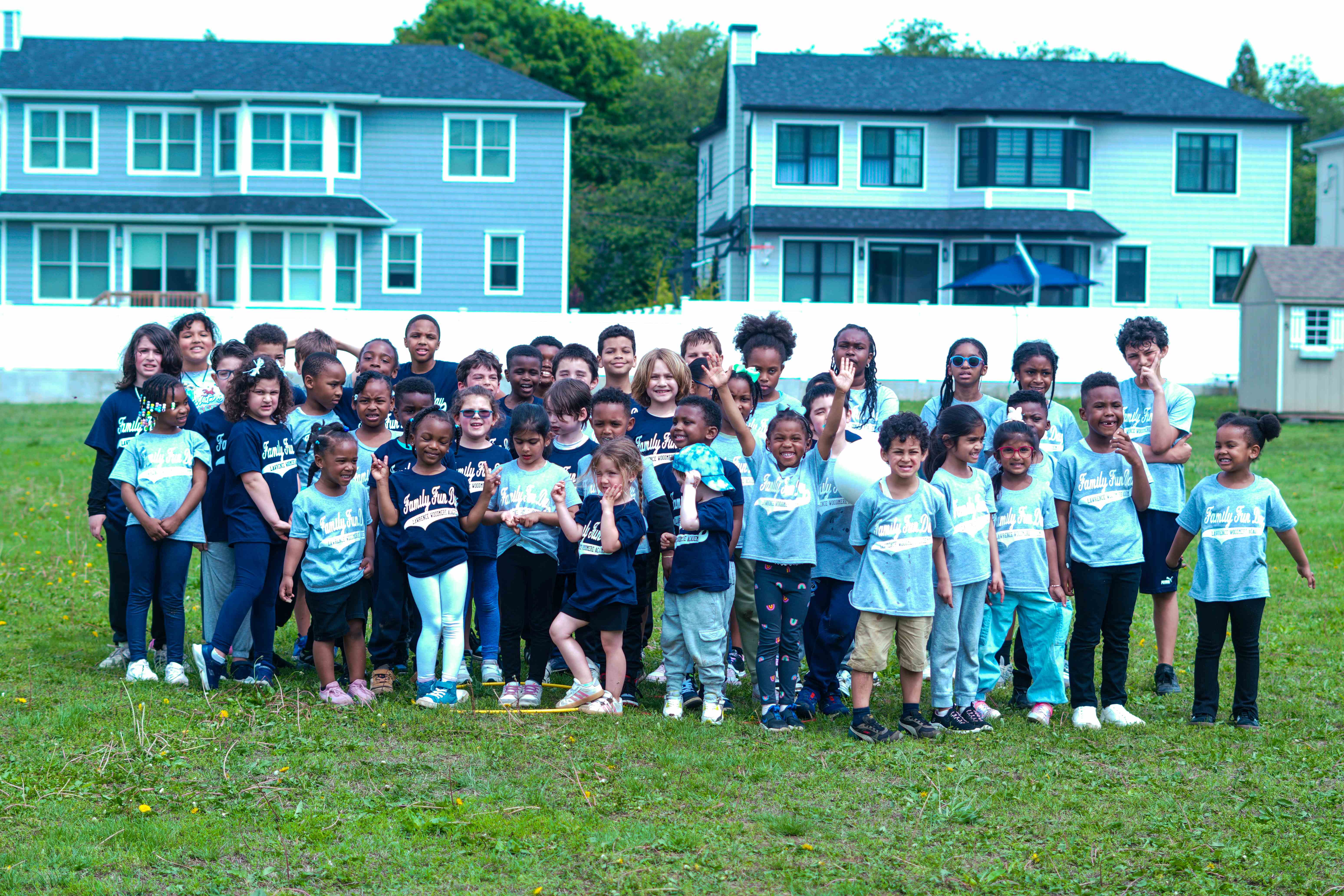 Group photo of kids waving at Family Fun Day community event