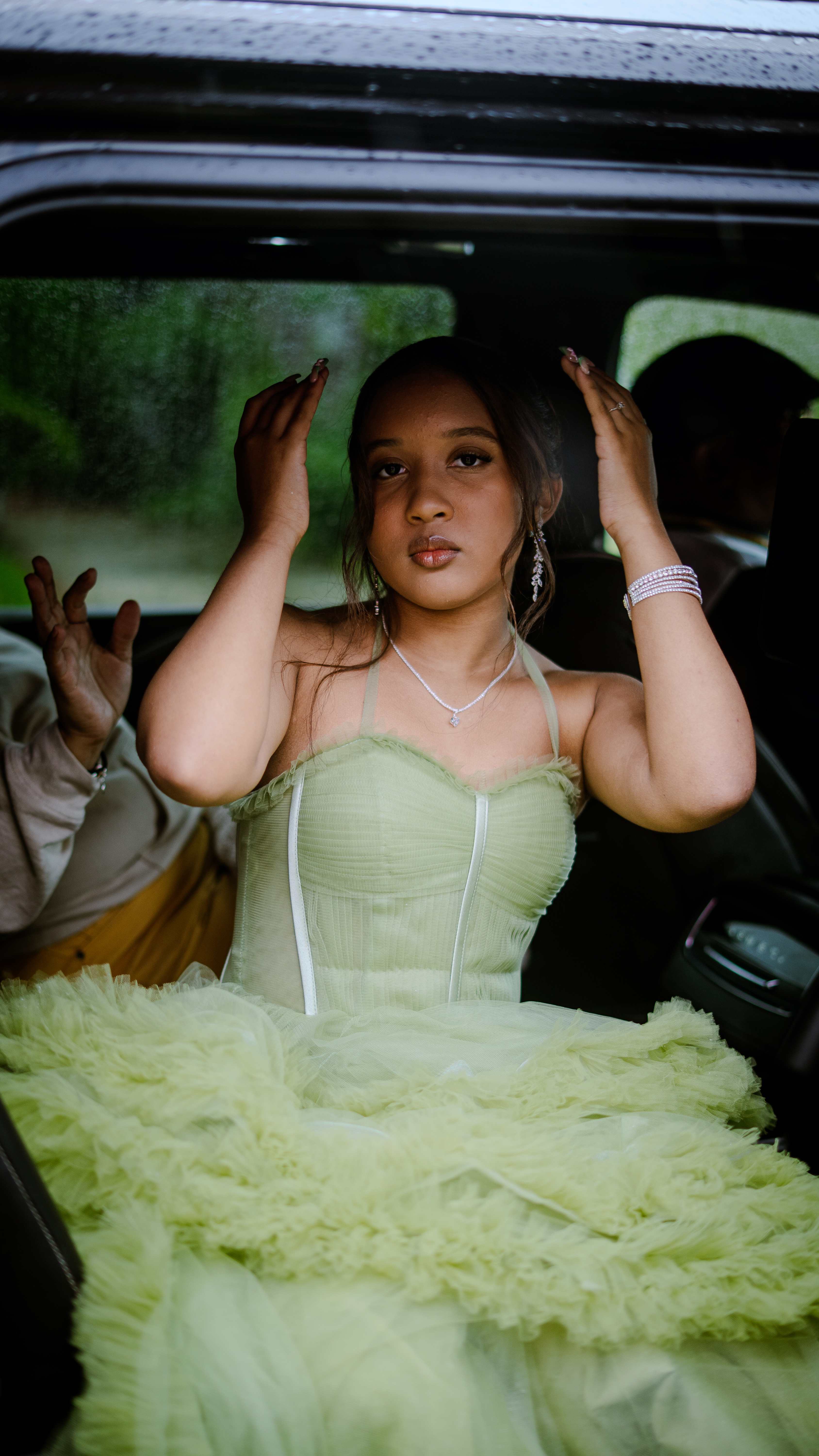 Graduate in car with formal dress