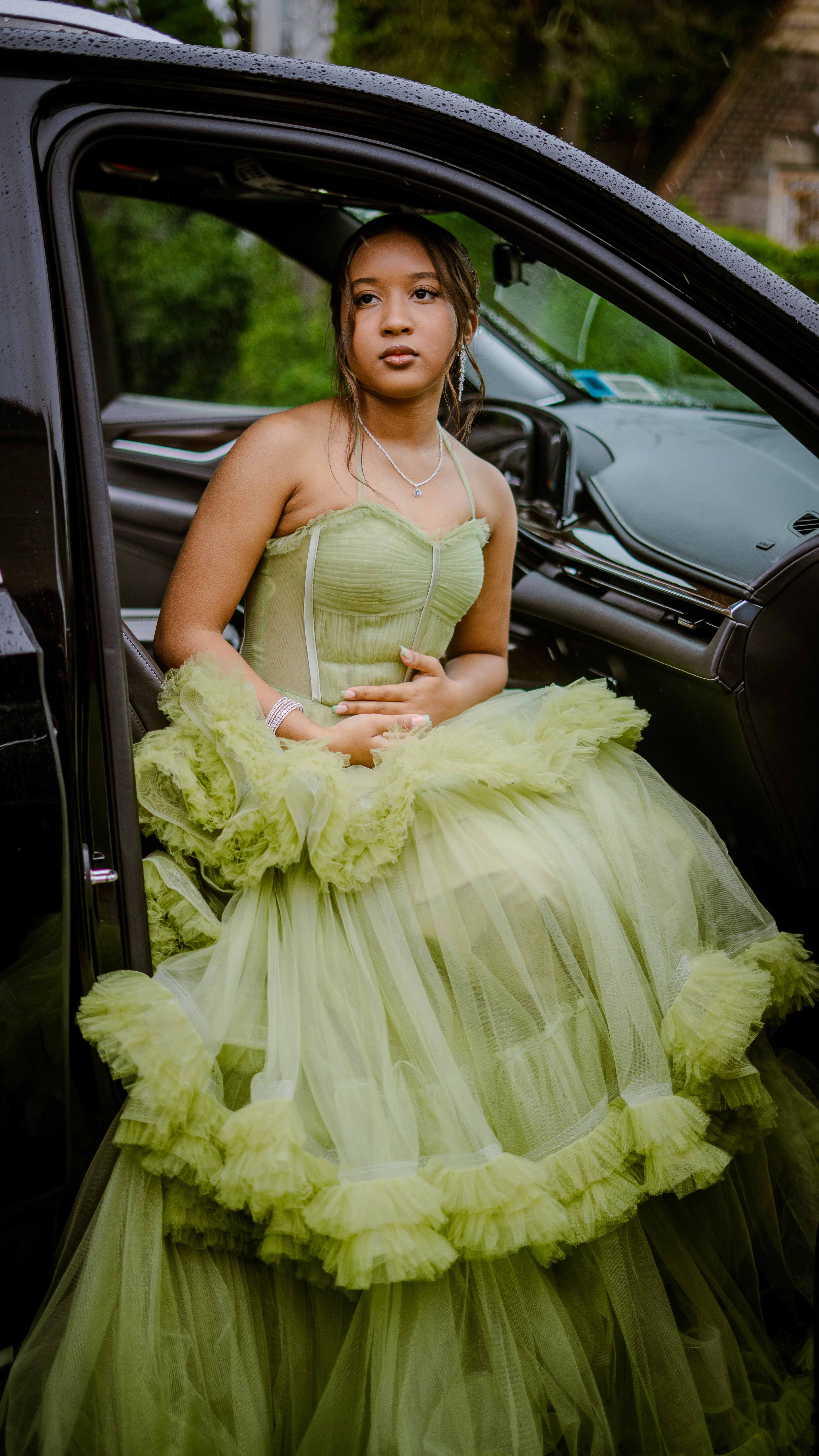 Graduate in car with mint green formal dress